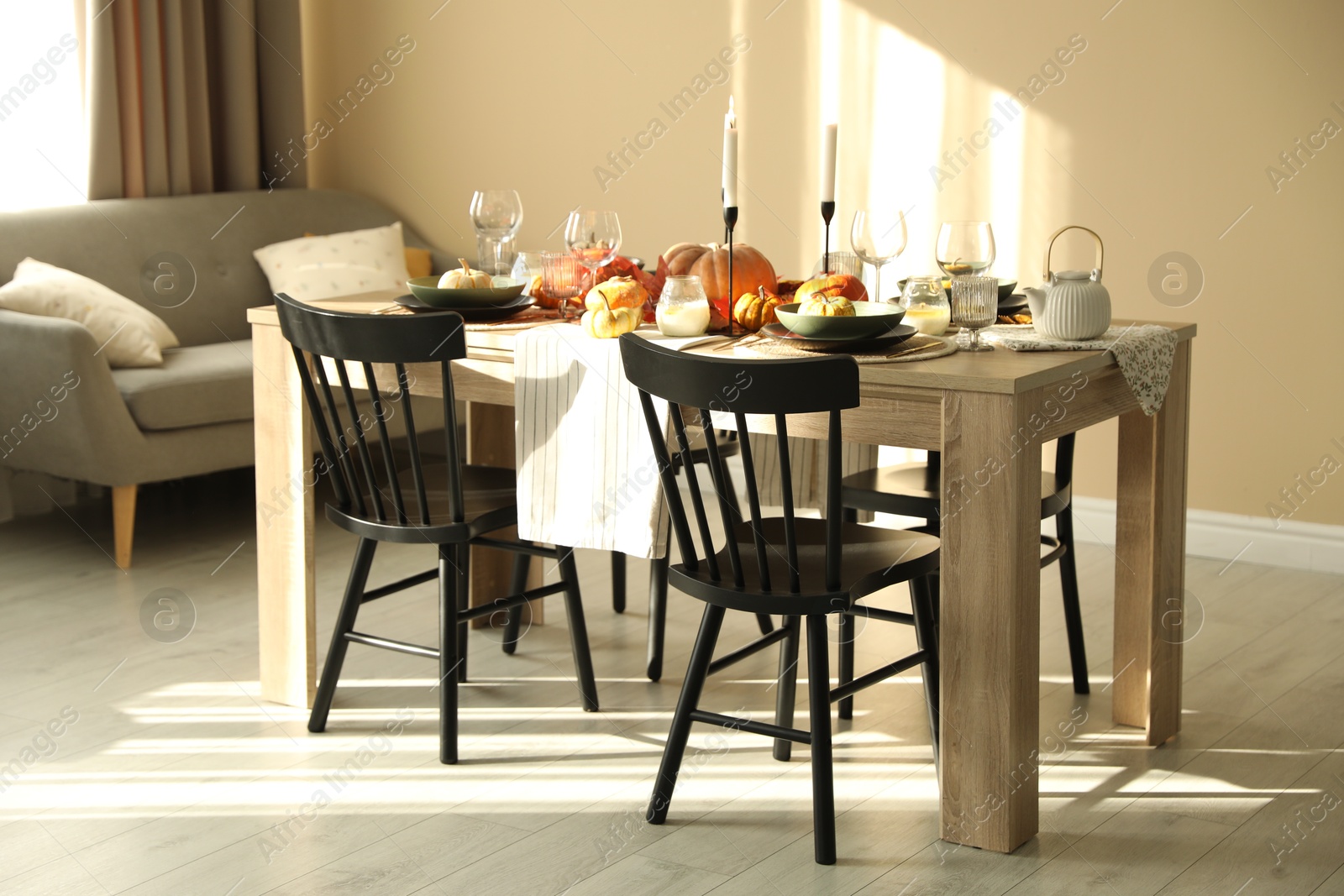 Photo of Stylish table setting with beautiful autumn decor in dining room