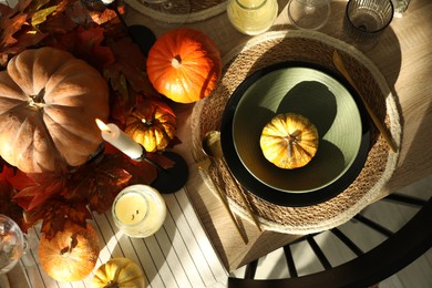 Photo of Stylish table setting with beautiful autumn decor in dining room, top view