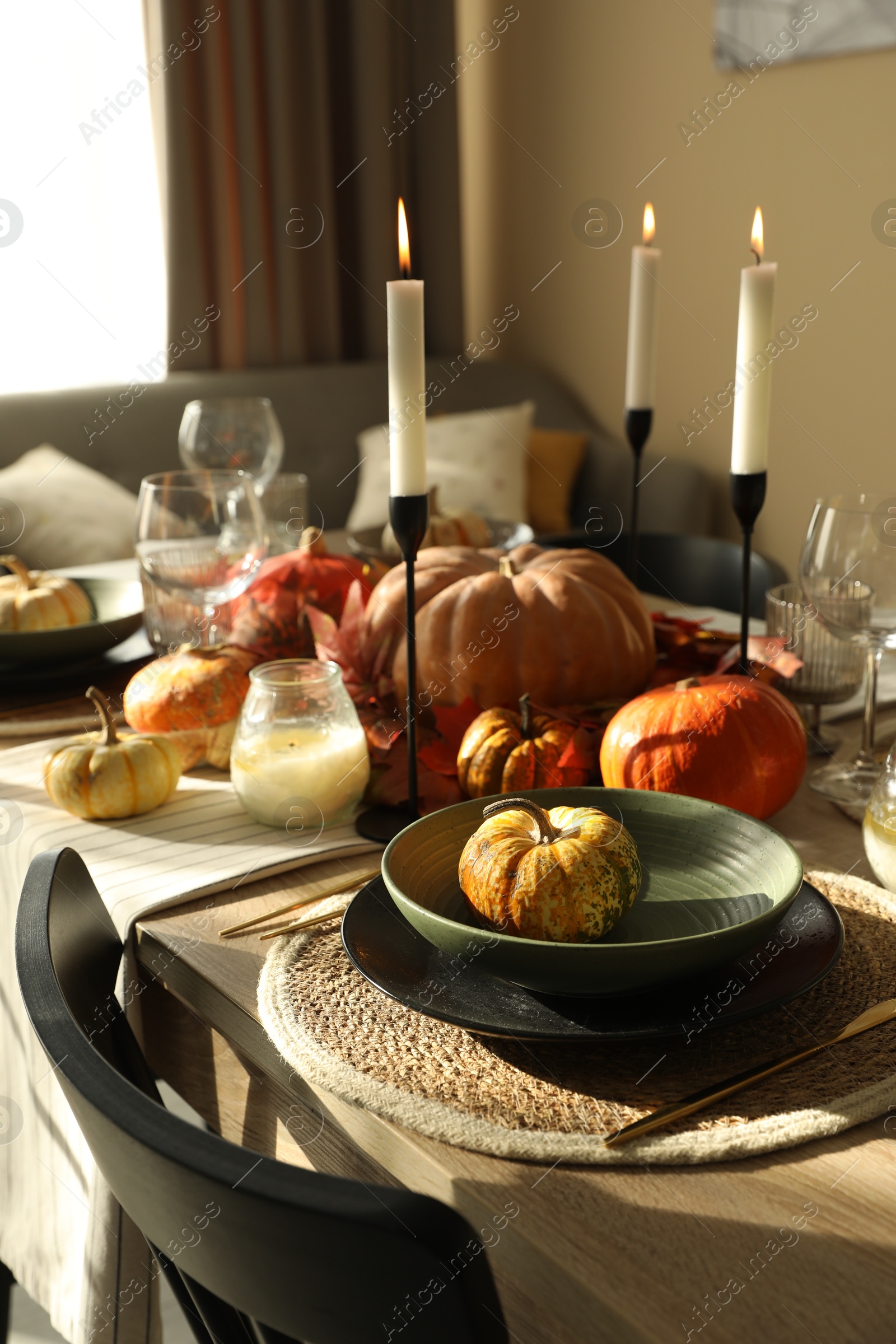 Photo of Stylish table setting with beautiful autumn decor in dining room