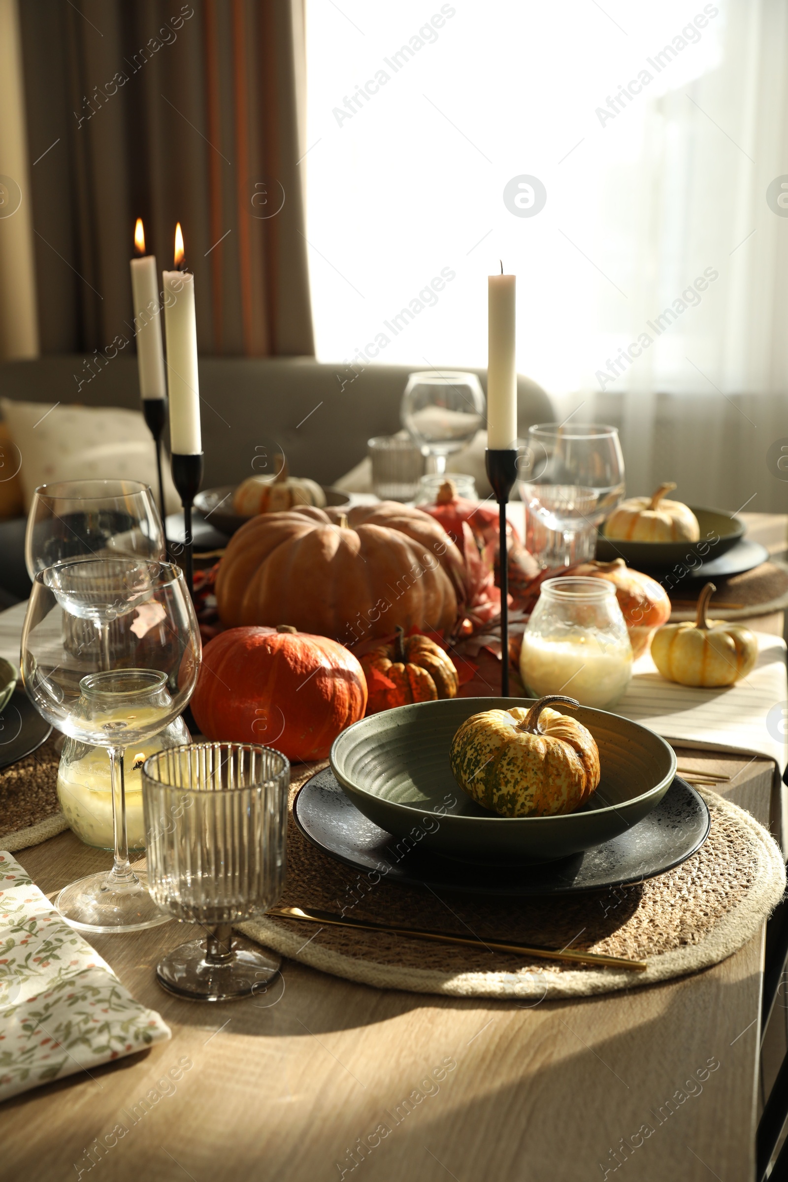 Photo of Stylish table setting with beautiful autumn decor in dining room