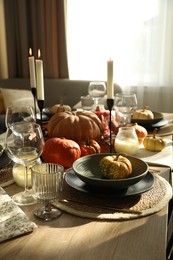 Stylish table setting with beautiful autumn decor in dining room