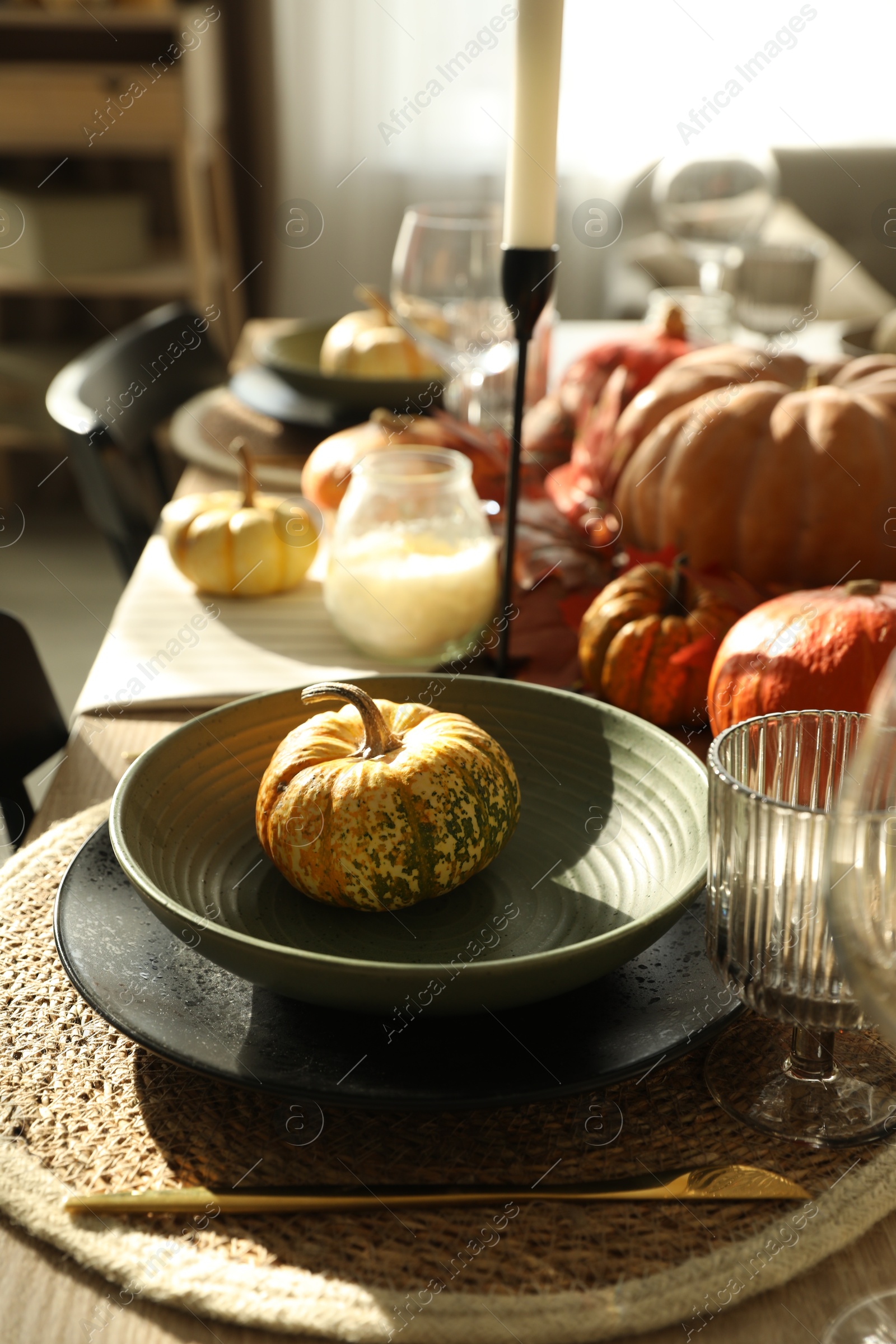 Photo of Stylish table setting with beautiful autumn decor in dining room