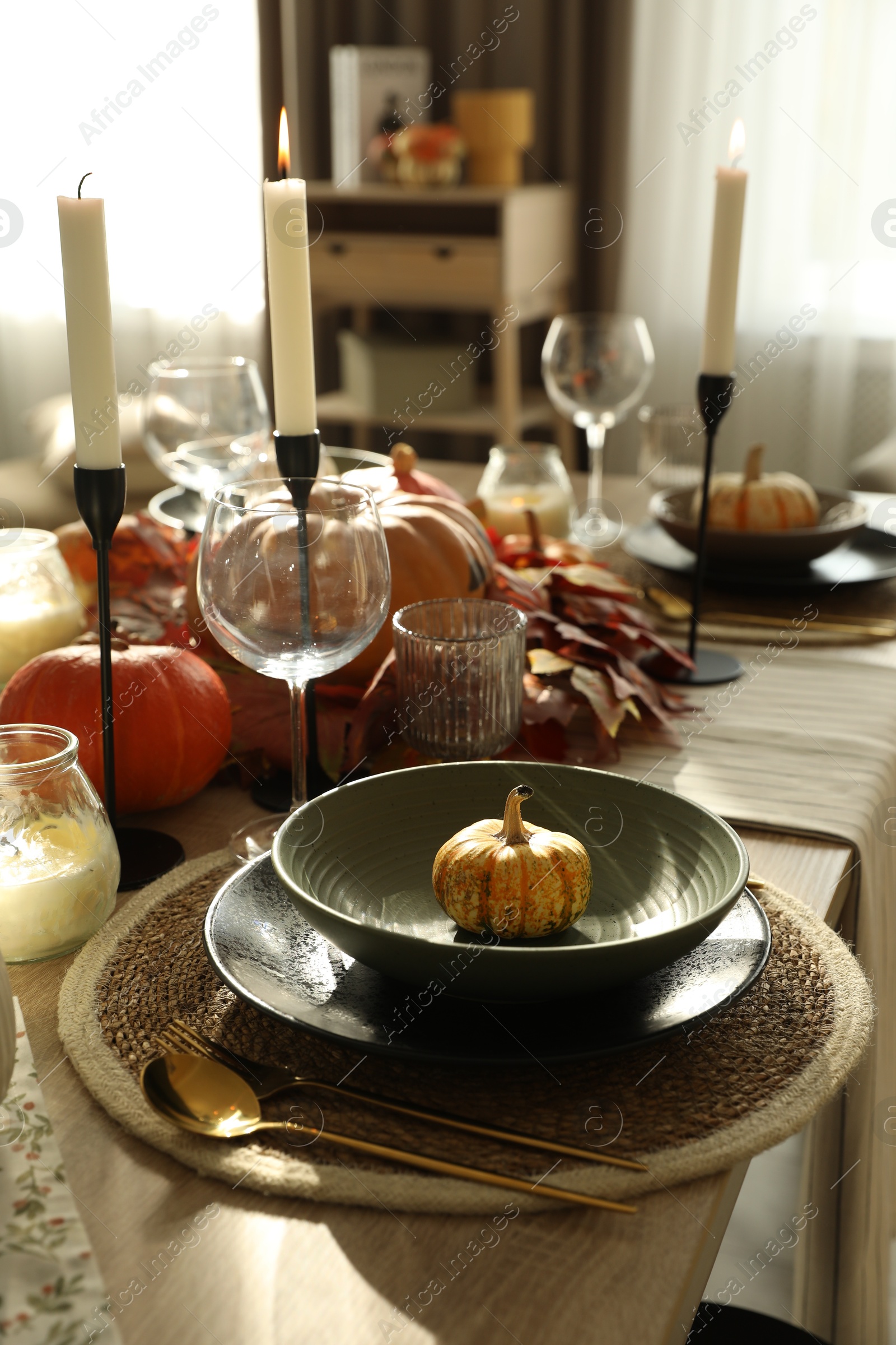 Photo of Stylish table setting with beautiful autumn decor in dining room