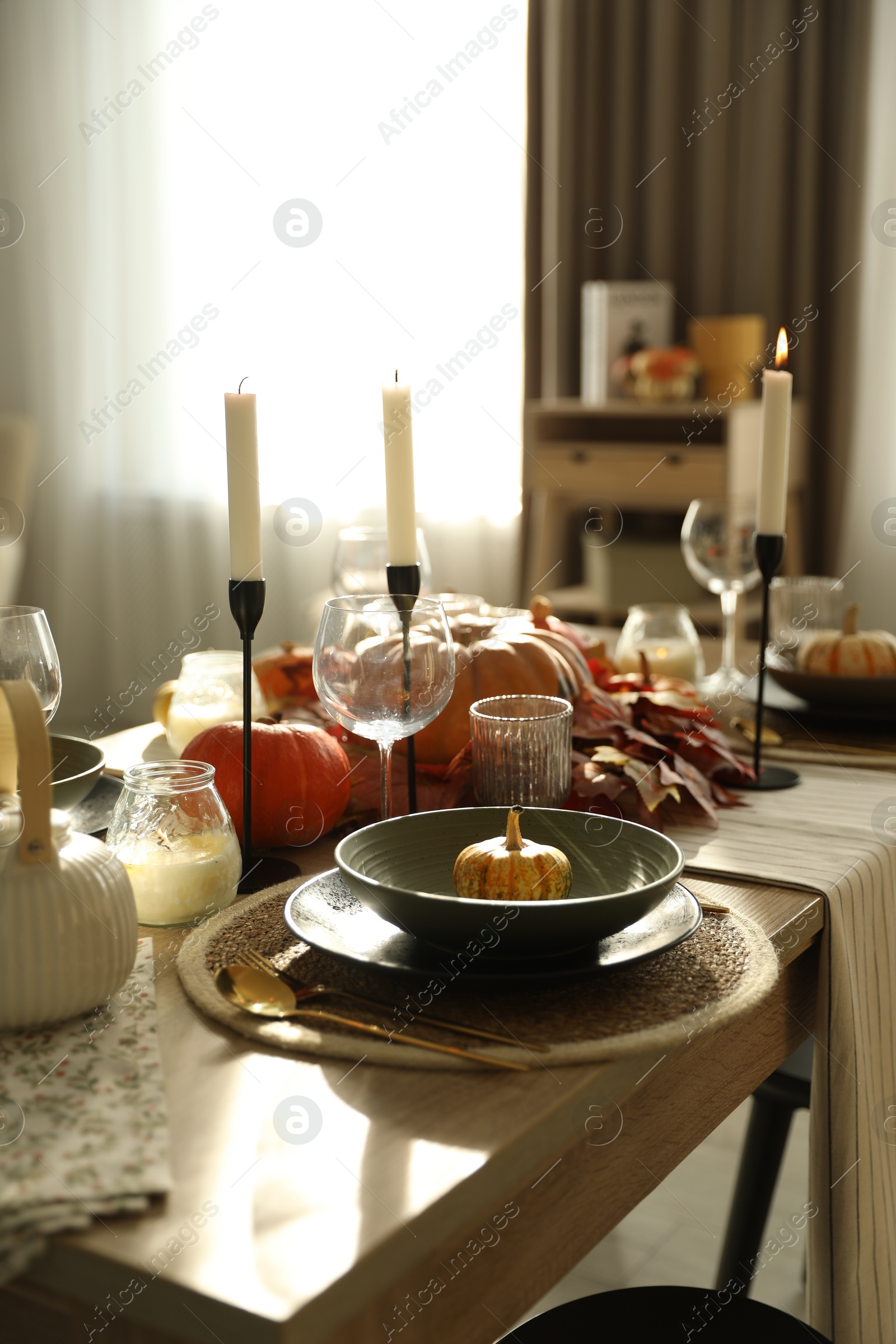 Photo of Stylish table setting with beautiful autumn decor in dining room