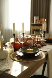 Stylish table setting with beautiful autumn decor in dining room