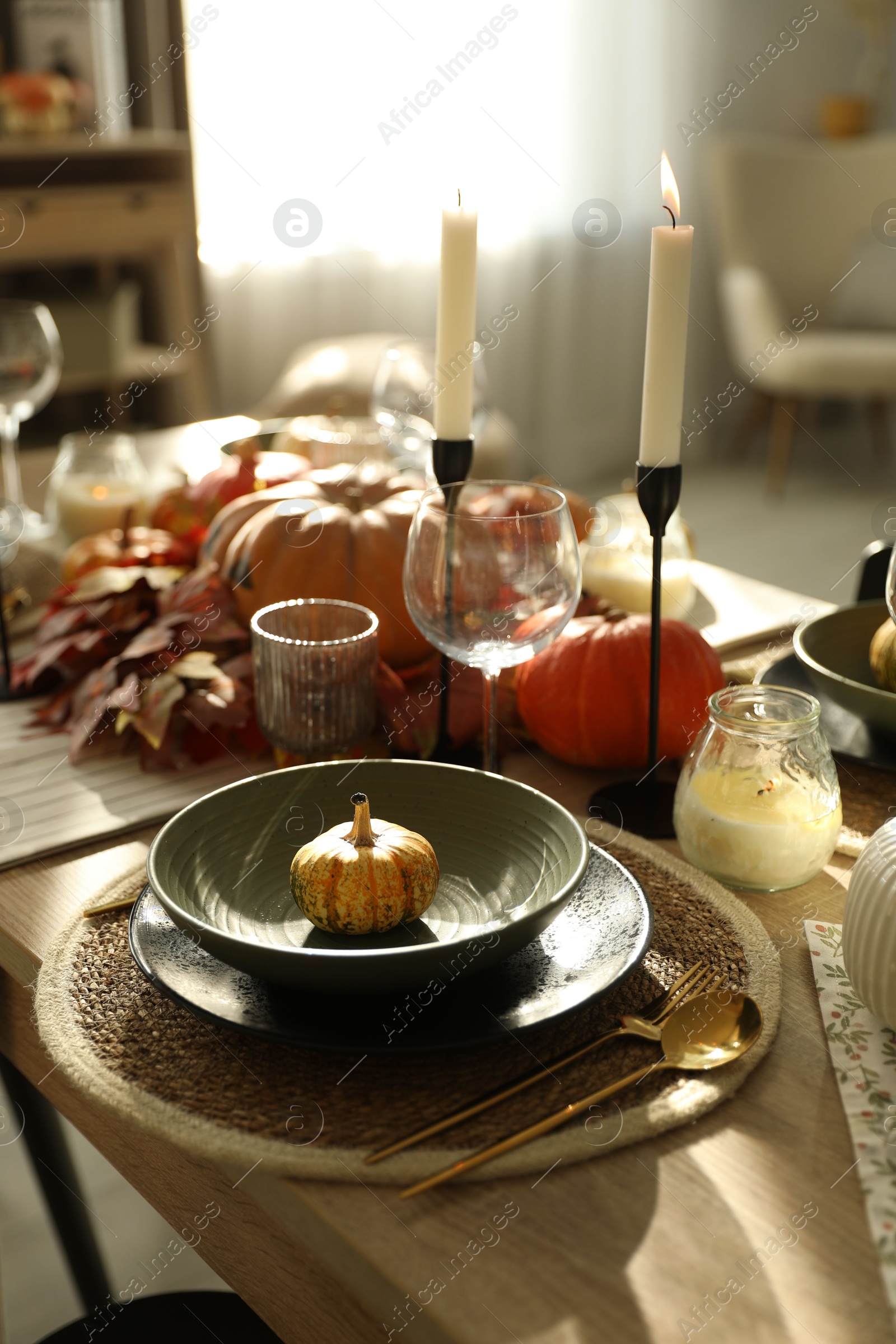 Photo of Stylish table setting with beautiful autumn decor in dining room