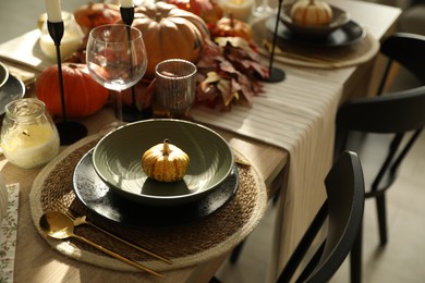 Photo of Stylish table setting with beautiful autumn decor in dining room