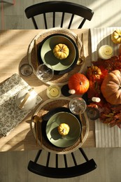 Stylish table setting with beautiful autumn decor in dining room, top view