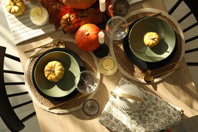 Photo of Stylish table setting with beautiful autumn decor in dining room, top view