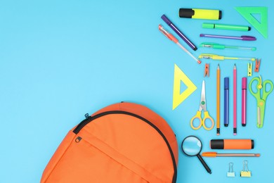 Photo of Backpack and different school supplies on light blue background, flat lay. Space for text