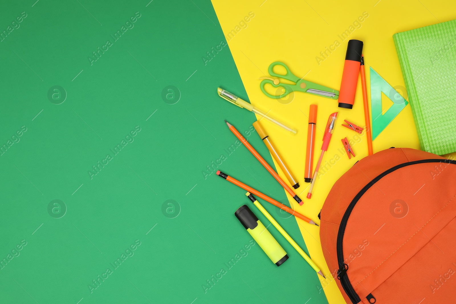 Photo of Backpack and different school supplies on color background, flat lay. Space for text