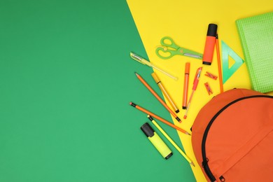 Photo of Backpack and different school supplies on color background, flat lay. Space for text