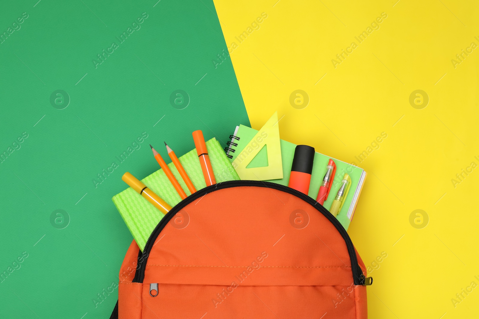 Photo of Backpack and different school supplies on color background, flat lay. Space for text