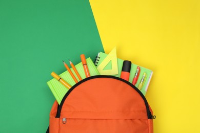 Photo of Backpack and different school supplies on color background, flat lay. Space for text