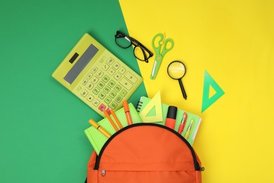 Photo of Backpack and different school supplies on color background, flat lay