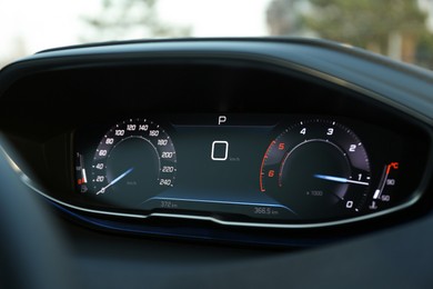 Photo of Speedometer on dashboard inside of modern luxury car, closeup