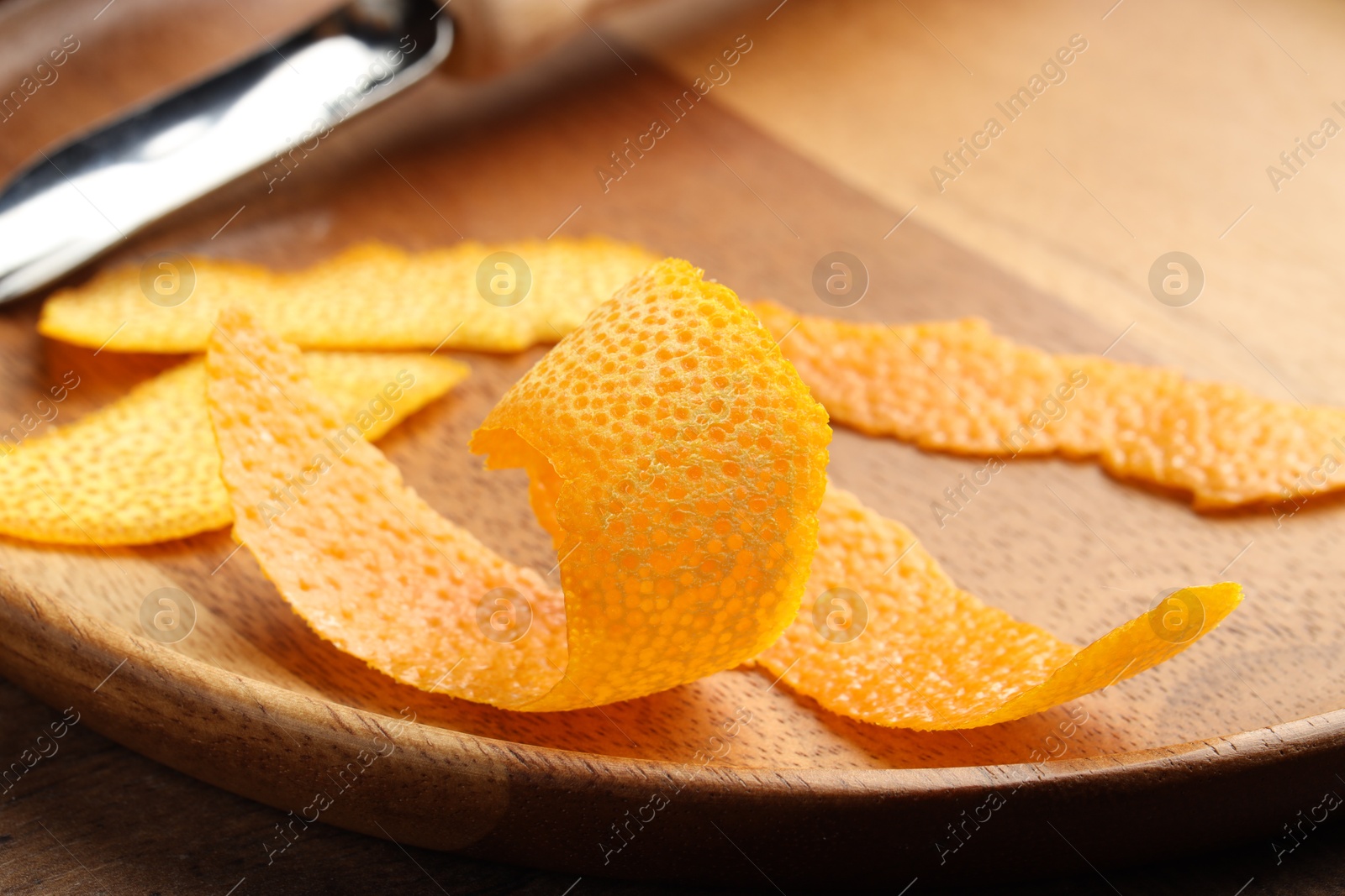 Photo of Fresh orange peel on wooden table, closeup