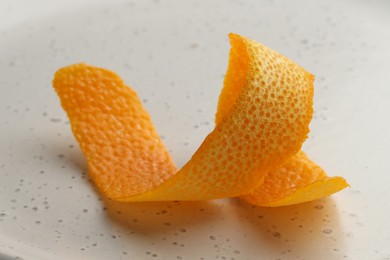 Photo of Fresh orange peel on light table, closeup