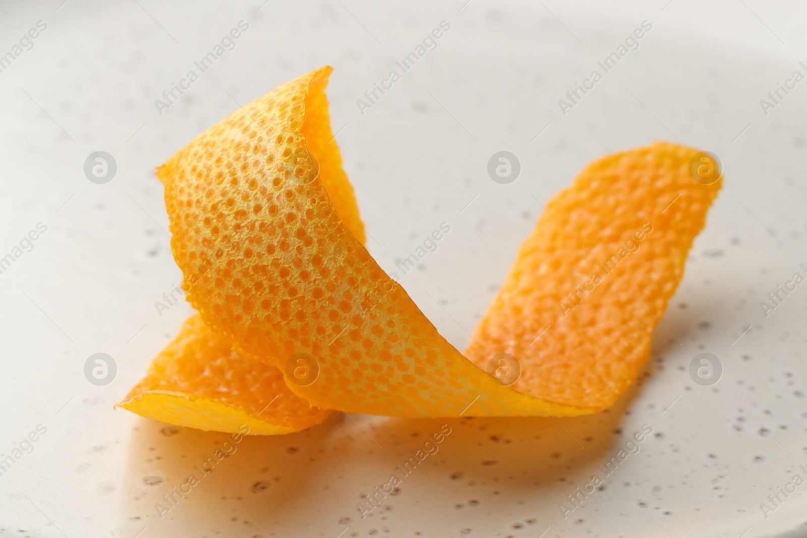 Photo of Fresh orange peel on light table, closeup