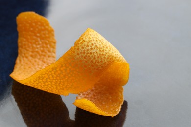 Photo of Fresh orange peel on dark table, closeup