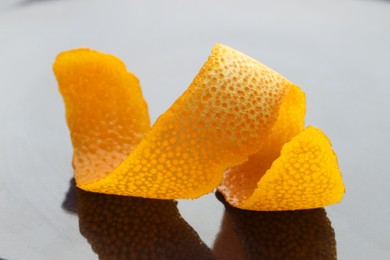 Photo of Fresh orange peel on dark table, closeup