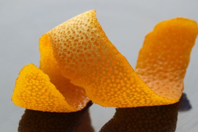 Photo of Fresh orange peel on dark table, closeup