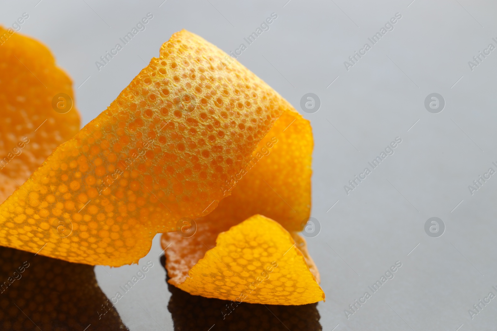 Photo of Fresh orange peel on dark table, closeup