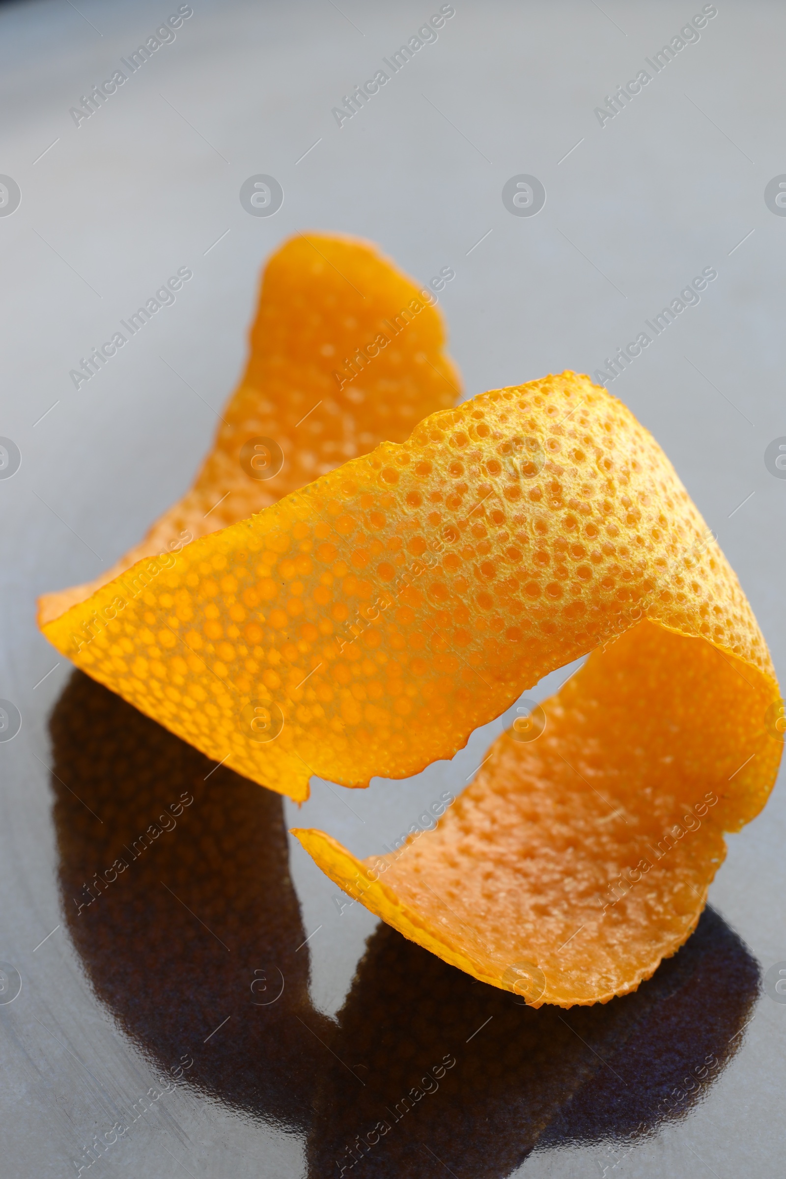 Photo of Fresh orange peel on dark table, closeup