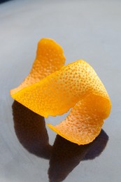 Photo of Fresh orange peel on dark table, closeup