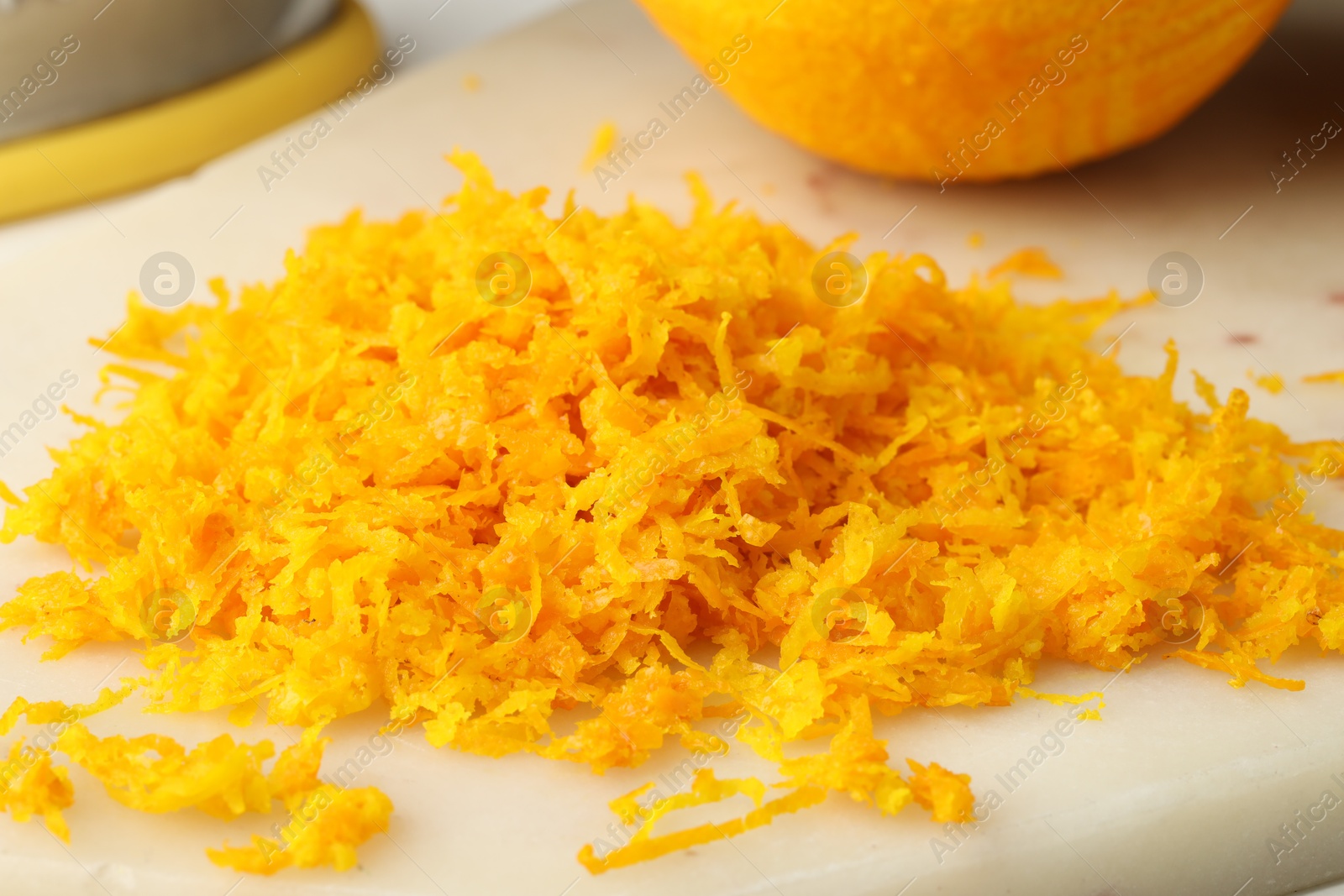 Photo of Fresh orange zest on light board, closeup