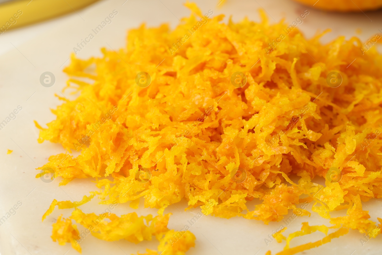 Photo of Fresh orange zest on light board, closeup