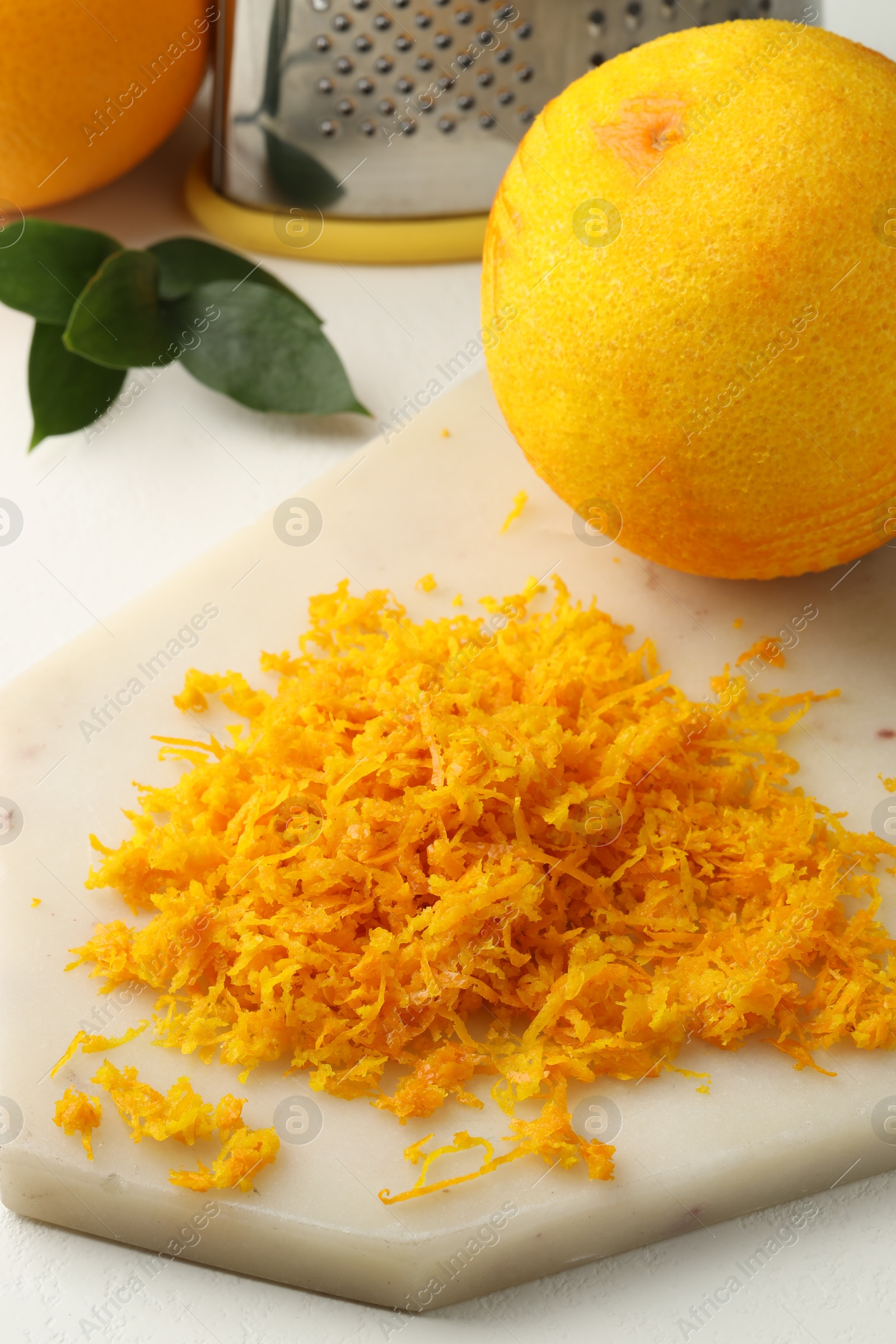 Photo of Fresh orange zest and fruits on light table