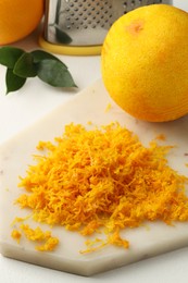 Photo of Fresh orange zest and fruits on light table