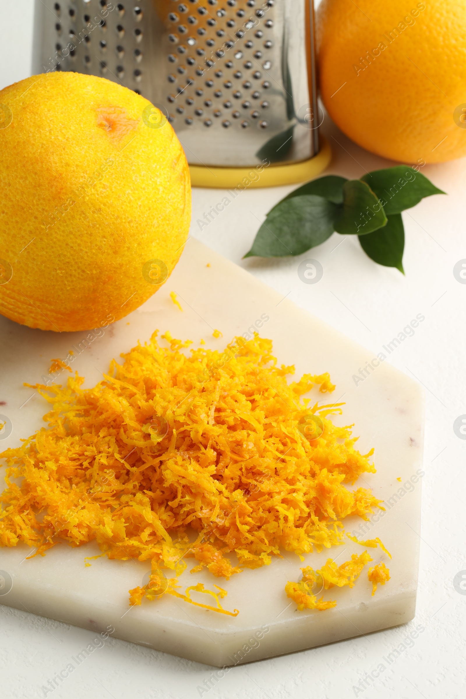 Photo of Fresh orange zest and fruits on light table