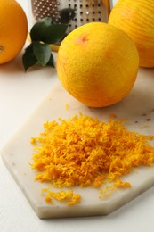 Photo of Fresh orange zest and fruits on light table