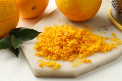 Photo of Fresh orange zest and fruits on light table, closeup