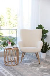 Photo of Stylish living room interior with soft white armchair