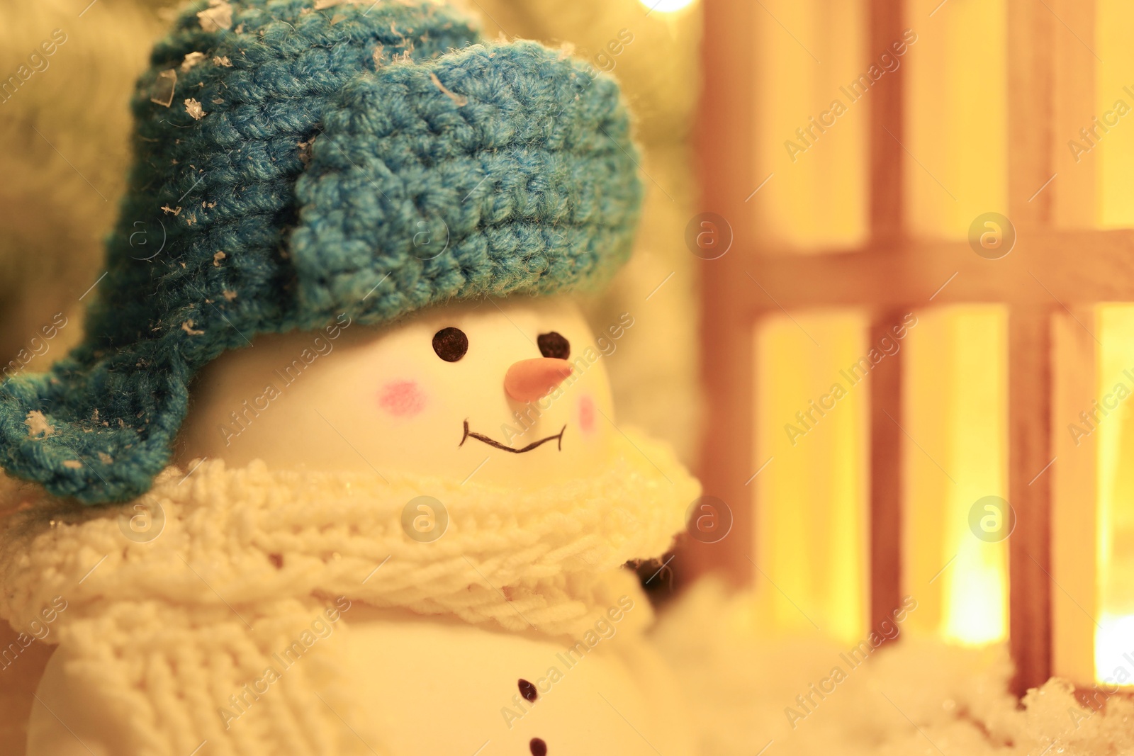 Photo of Cute decorative snowman against blurred background, closeup