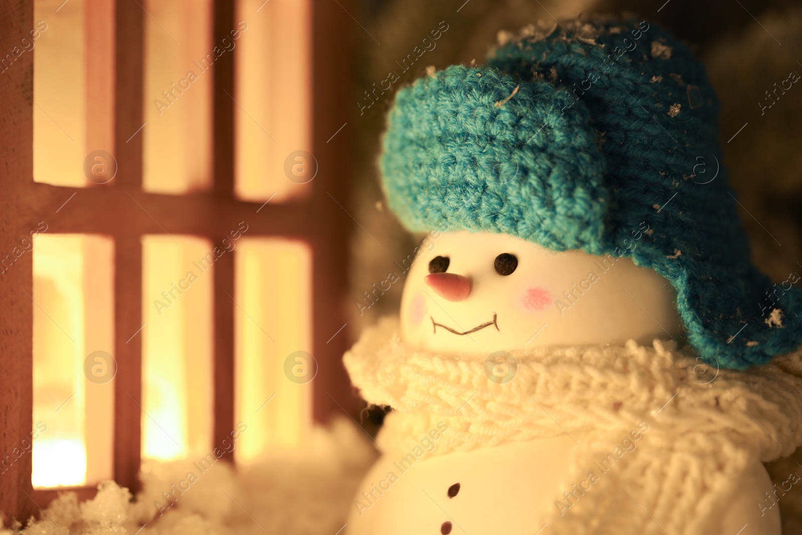 Photo of Cute decorative snowman against blurred background, closeup