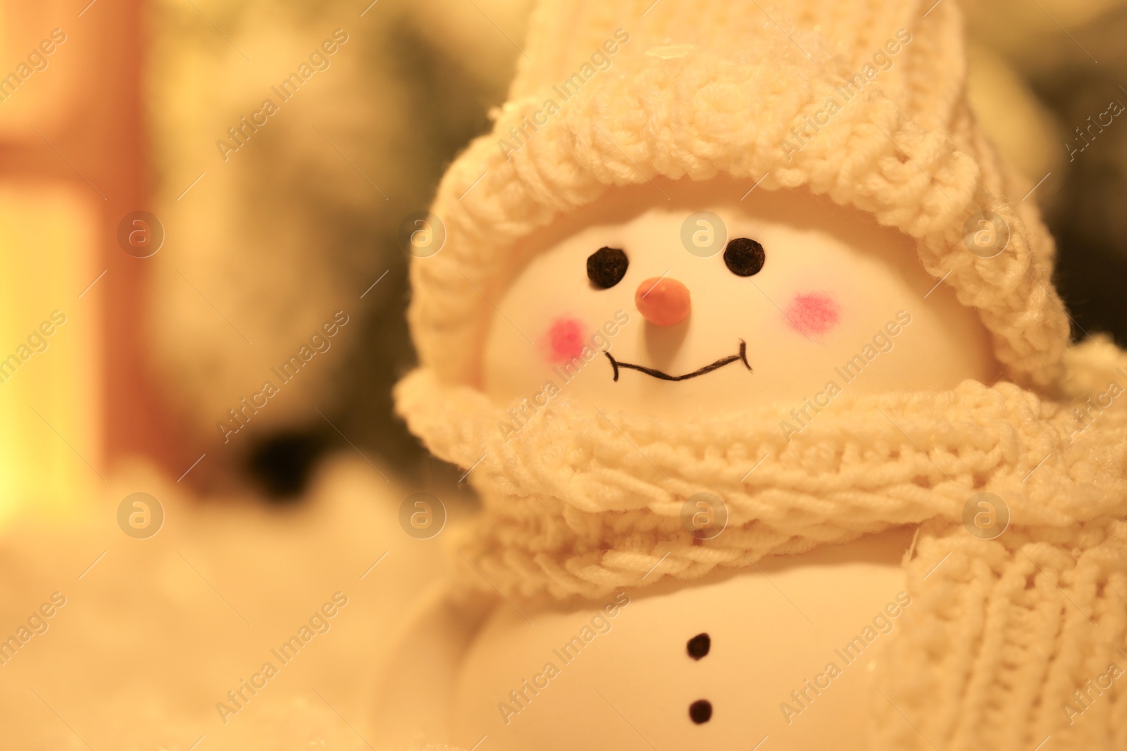 Photo of Cute decorative snowman against blurred background, closeup