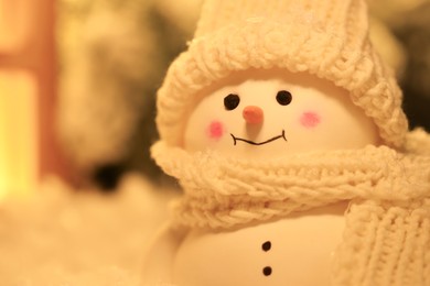 Photo of Cute decorative snowman against blurred background, closeup