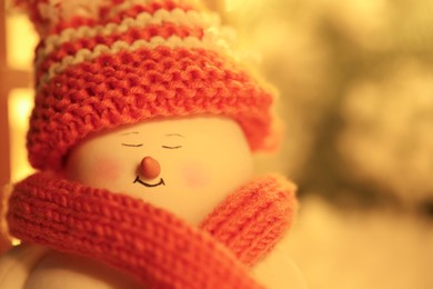 Photo of Cute decorative snowman against blurred background, closeup