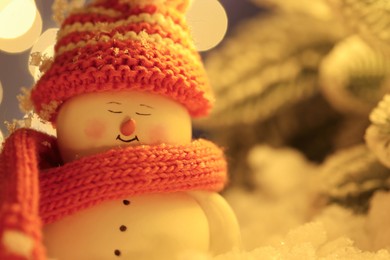 Photo of Cute decorative snowman against blurred background, closeup