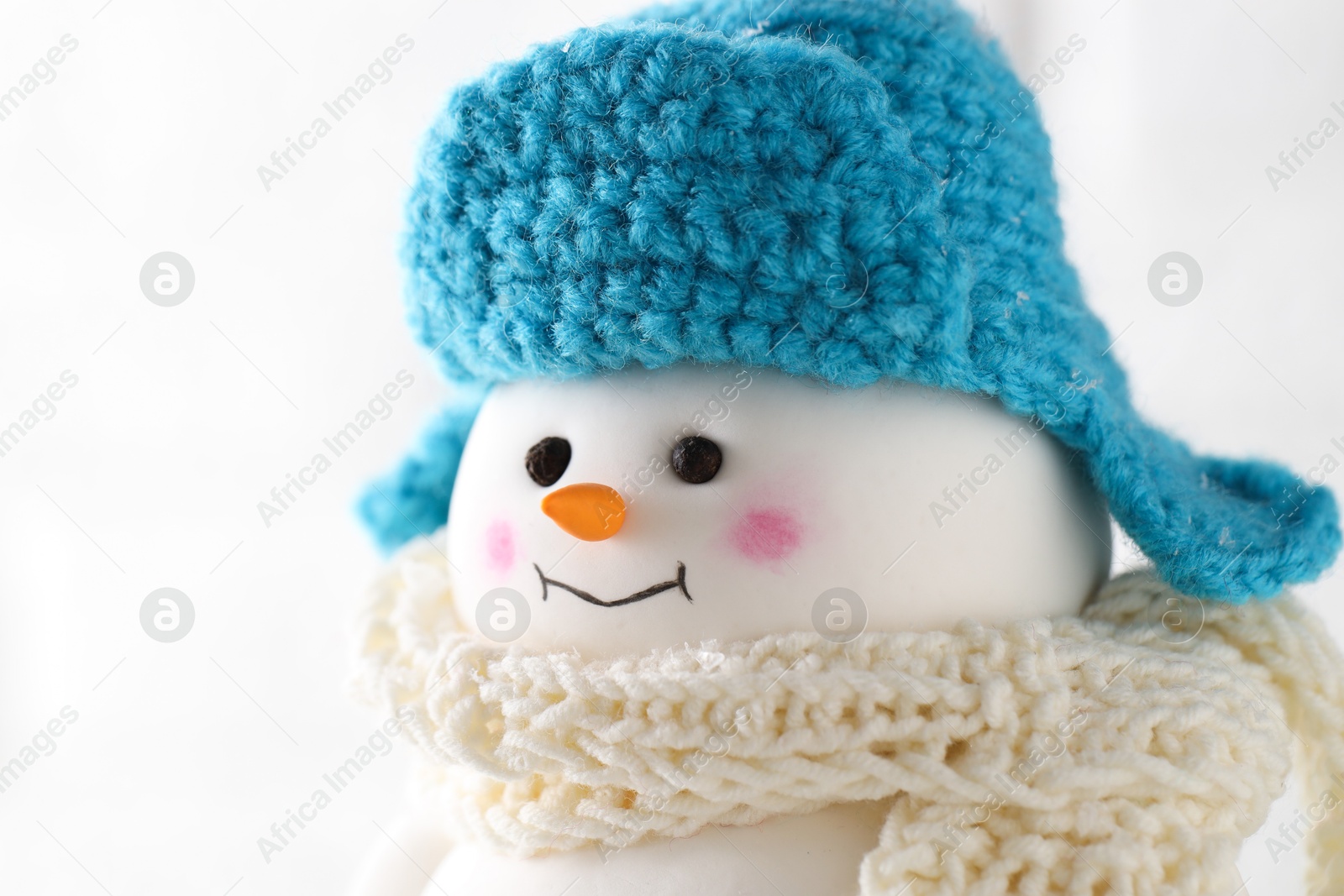 Photo of Cute decorative snowman against white background, closeup