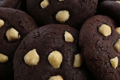 Photo of Tasty chocolate cookies with hazelnuts, closeup view