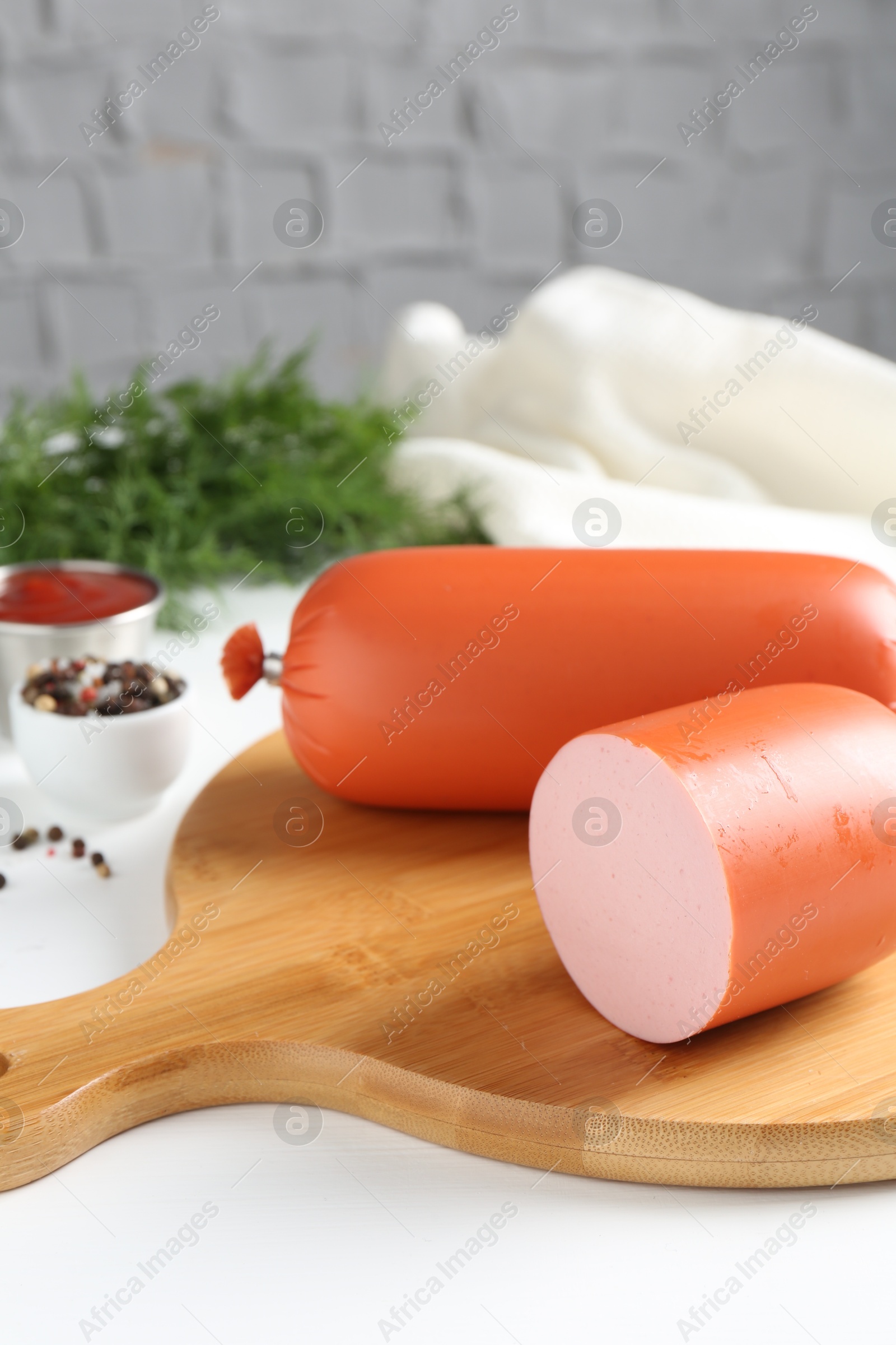 Photo of Tasty boiled sausages and spices on white table