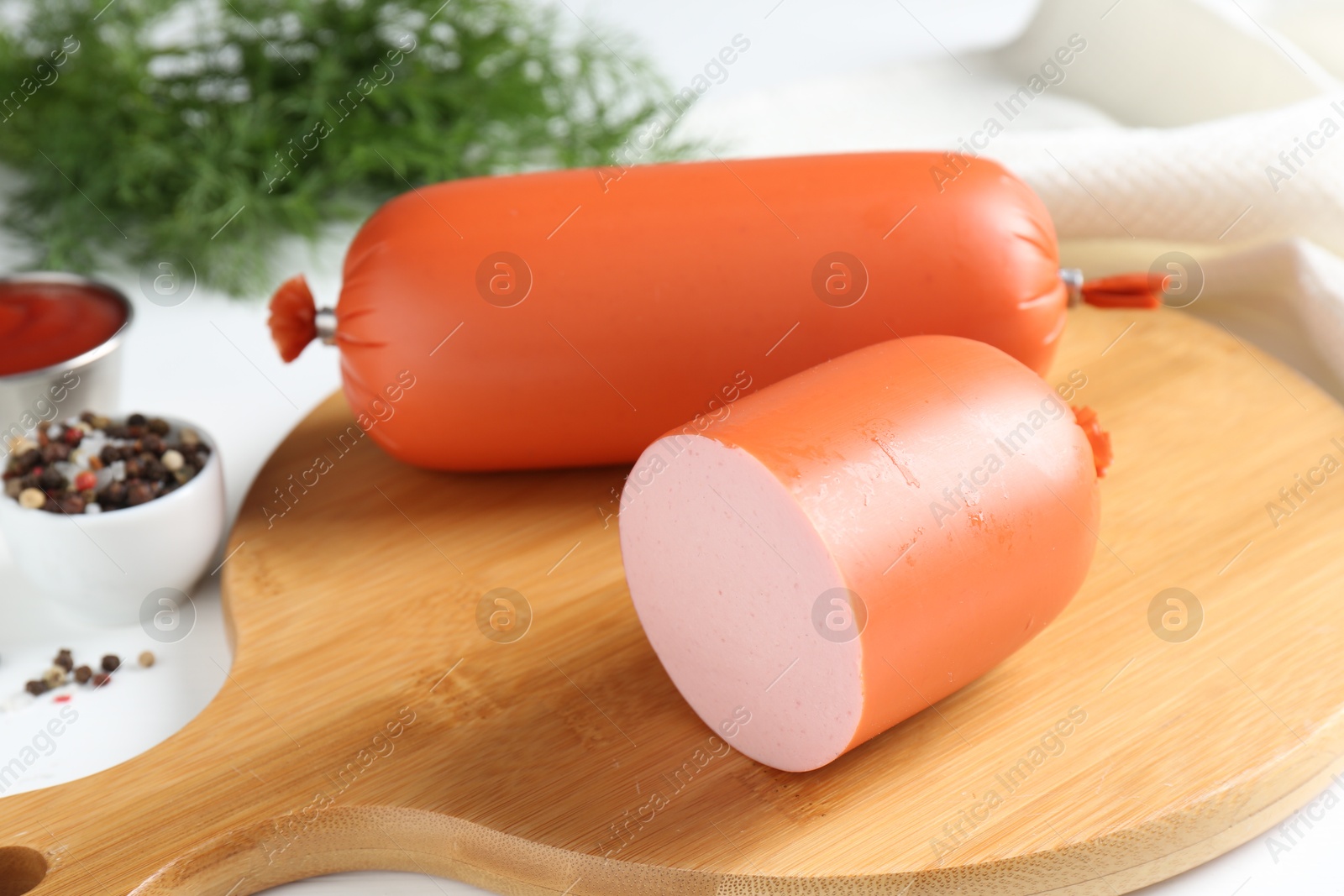 Photo of Tasty boiled sausages and spices on white table, closeup