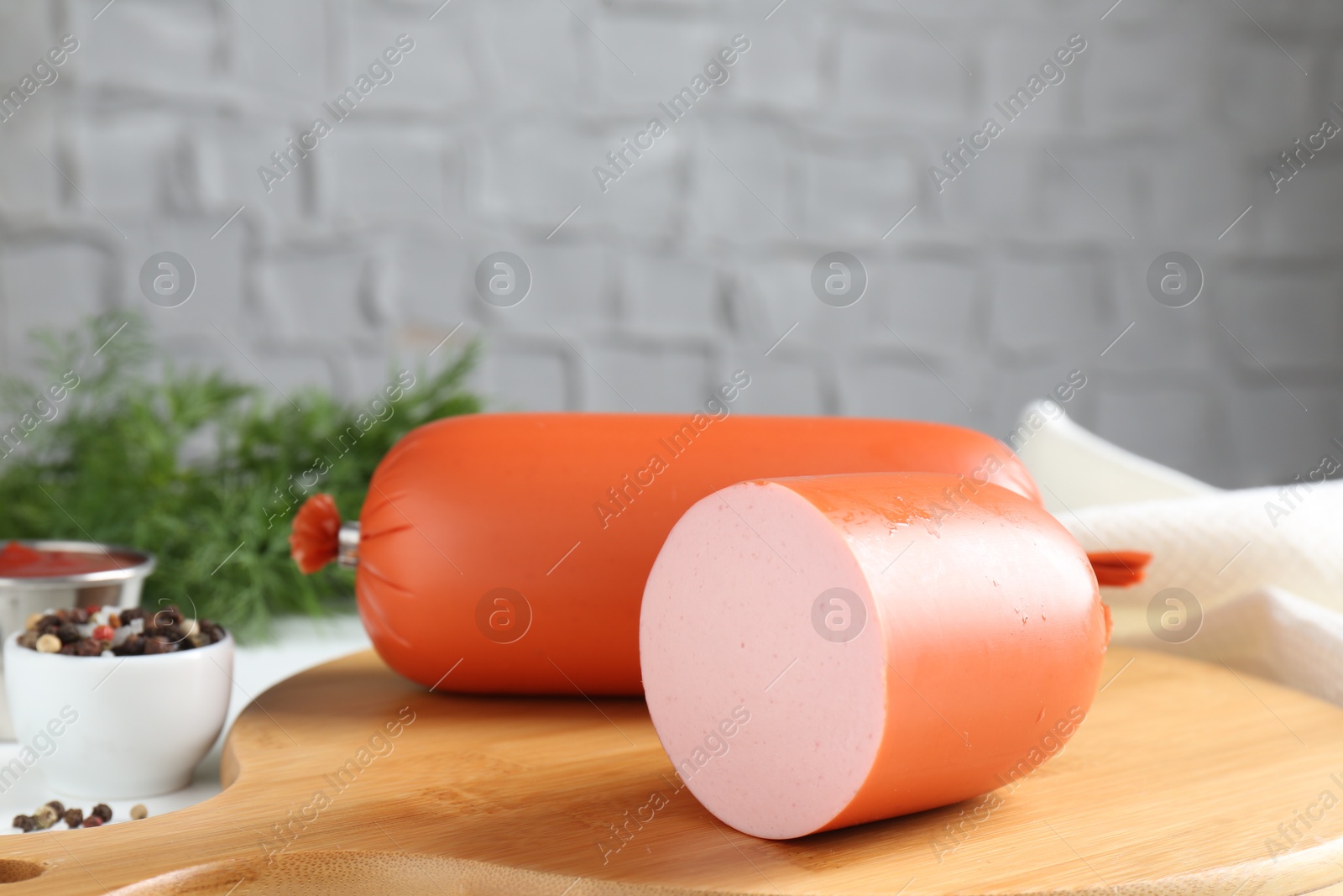 Photo of Tasty boiled sausages and spices on table, closeup