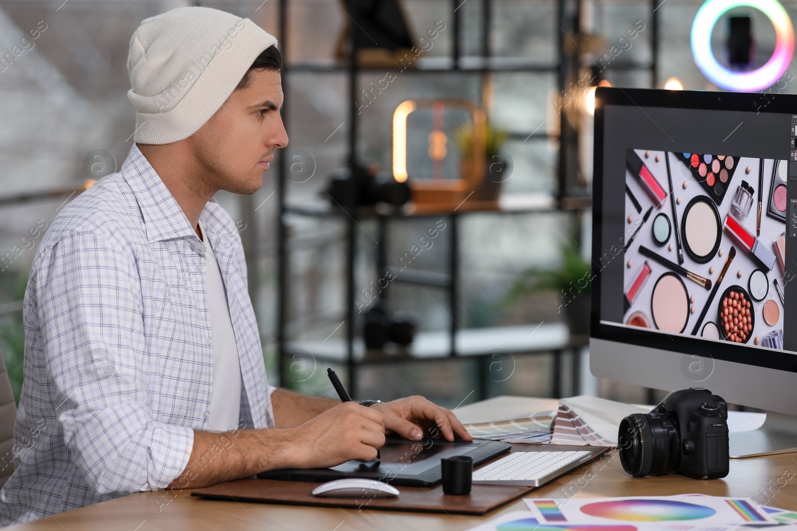 Photo of Professional retoucher working on computer in office