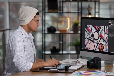 Photo of Professional retoucher working on computer in office